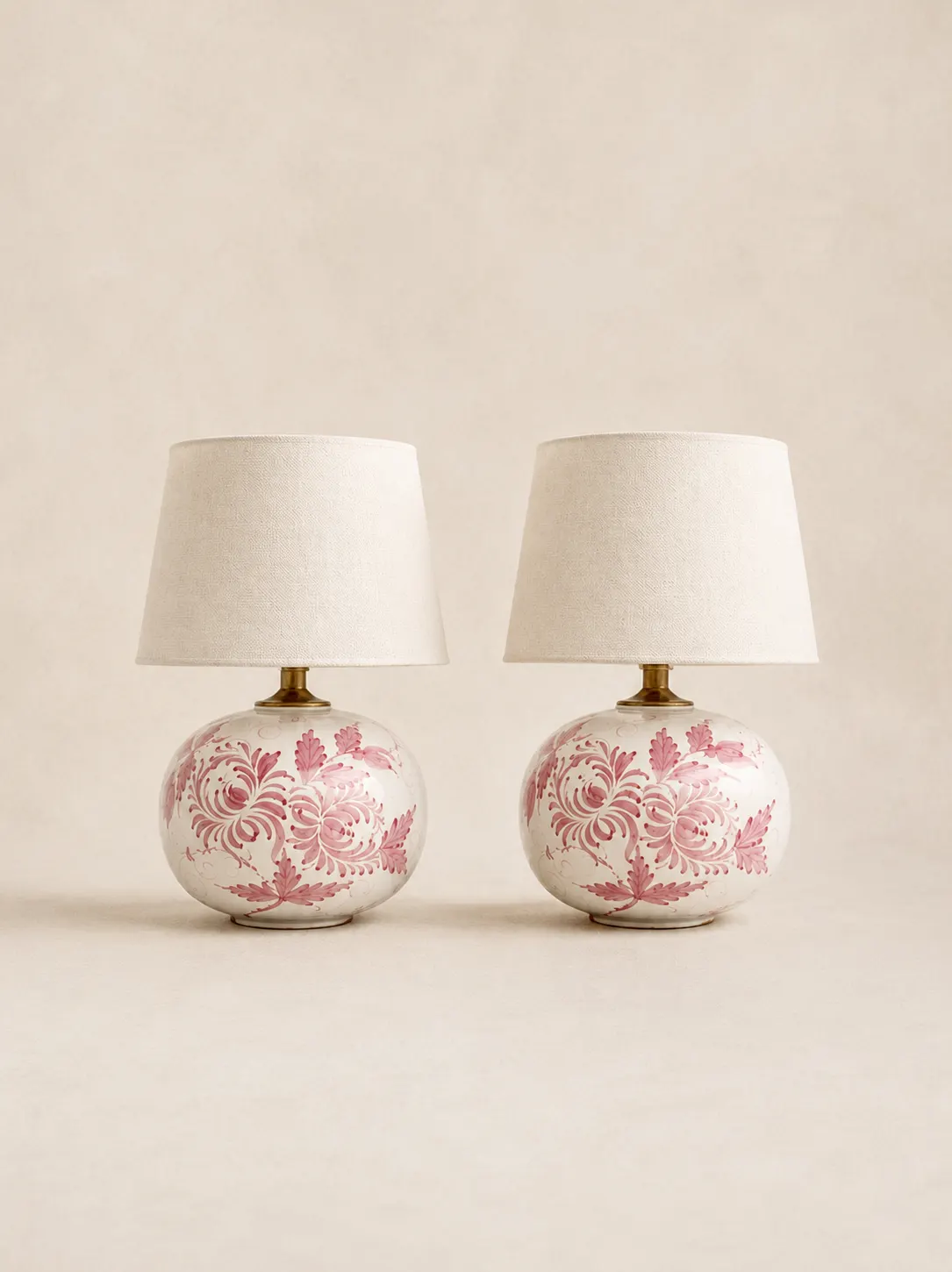 Pair of hand-painted pink floral ceramic table lights with linen shades.