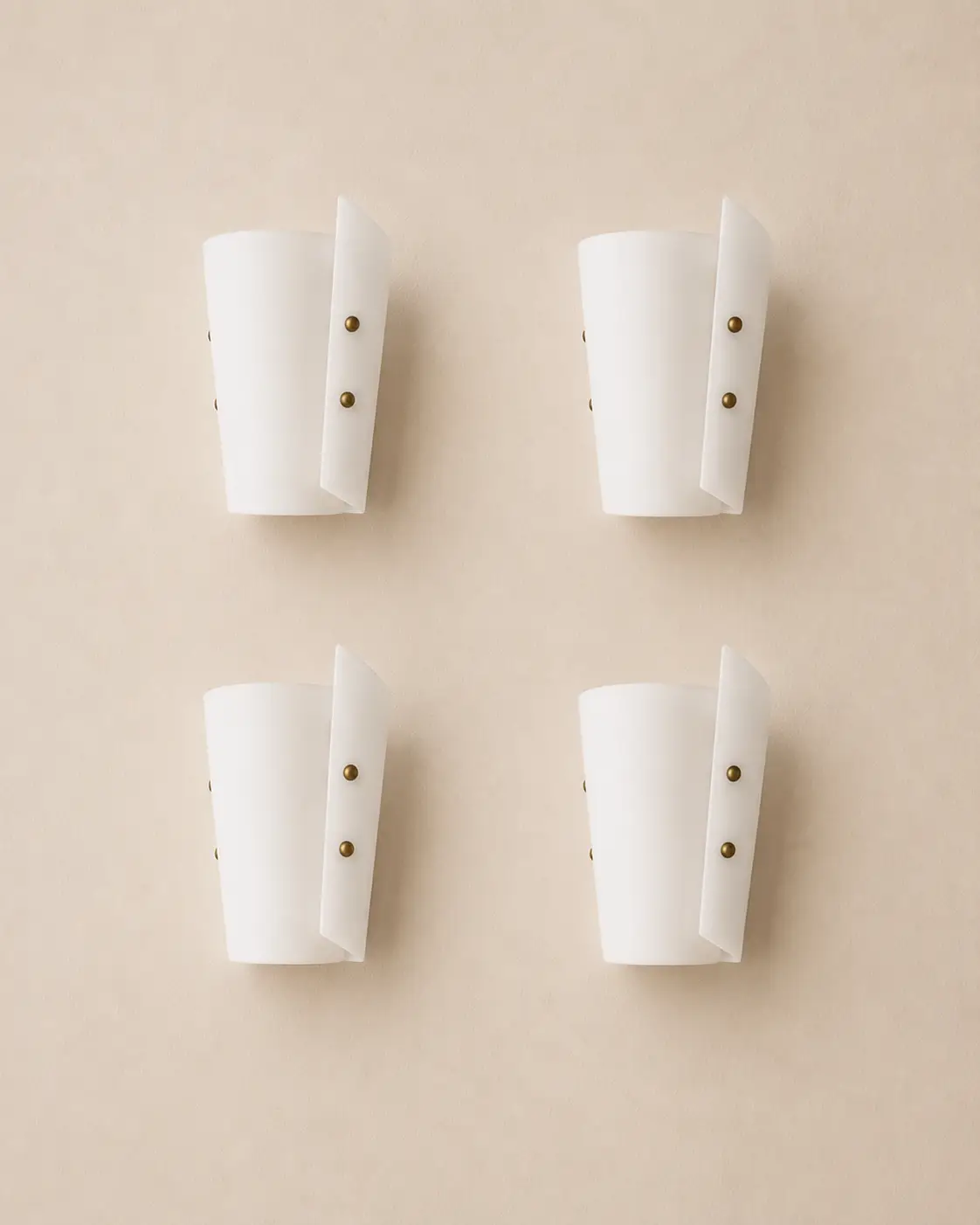 Set of six minimalist frosted glass wall sconces with brass details.